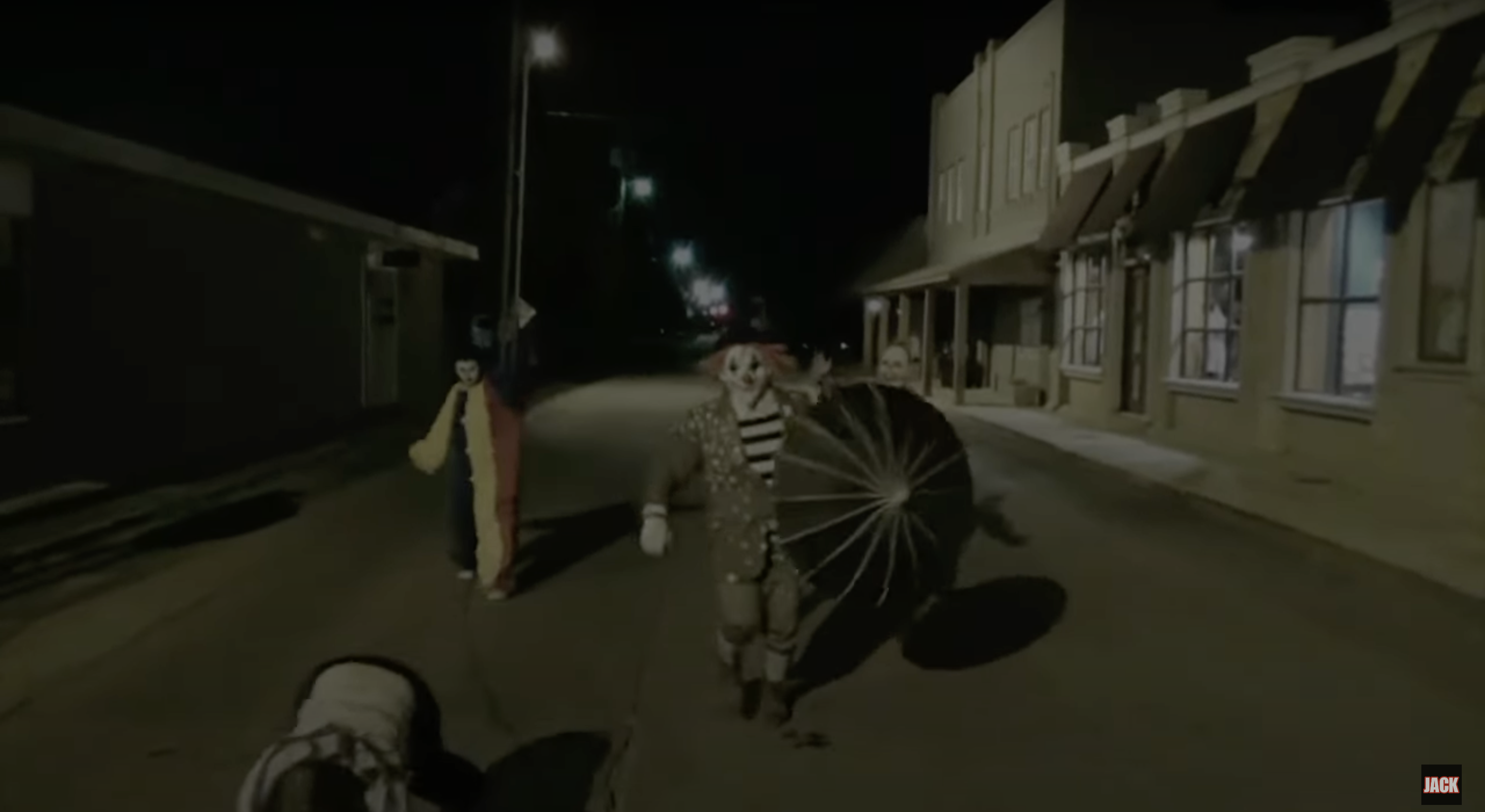 A trio of clowns walk down an alley on security cam footage