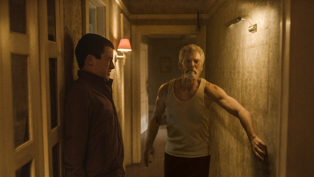 Dylan Minnette (left) and Stephen Lang star in Screen Gems’ horror-thriller DON’T BREATHE.