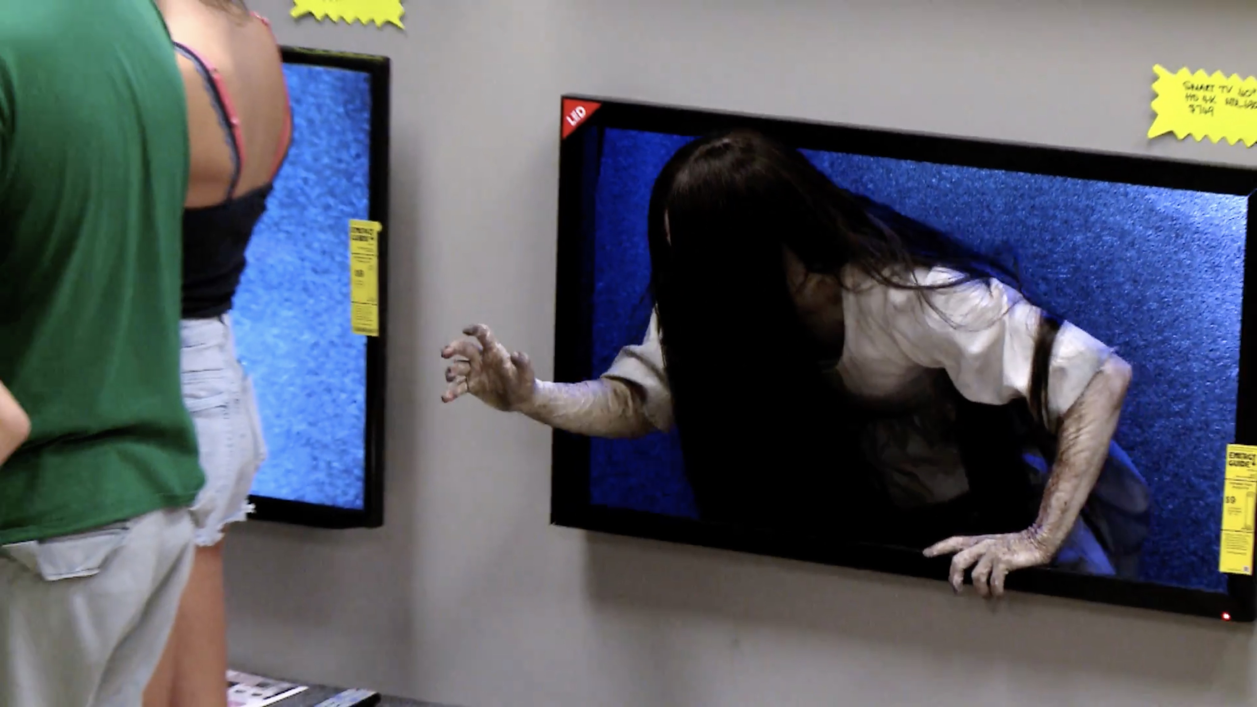 Watch the 'Rings' Girl Prank Customers by Crawling Out of Televisions! -  Bloody Disgusting