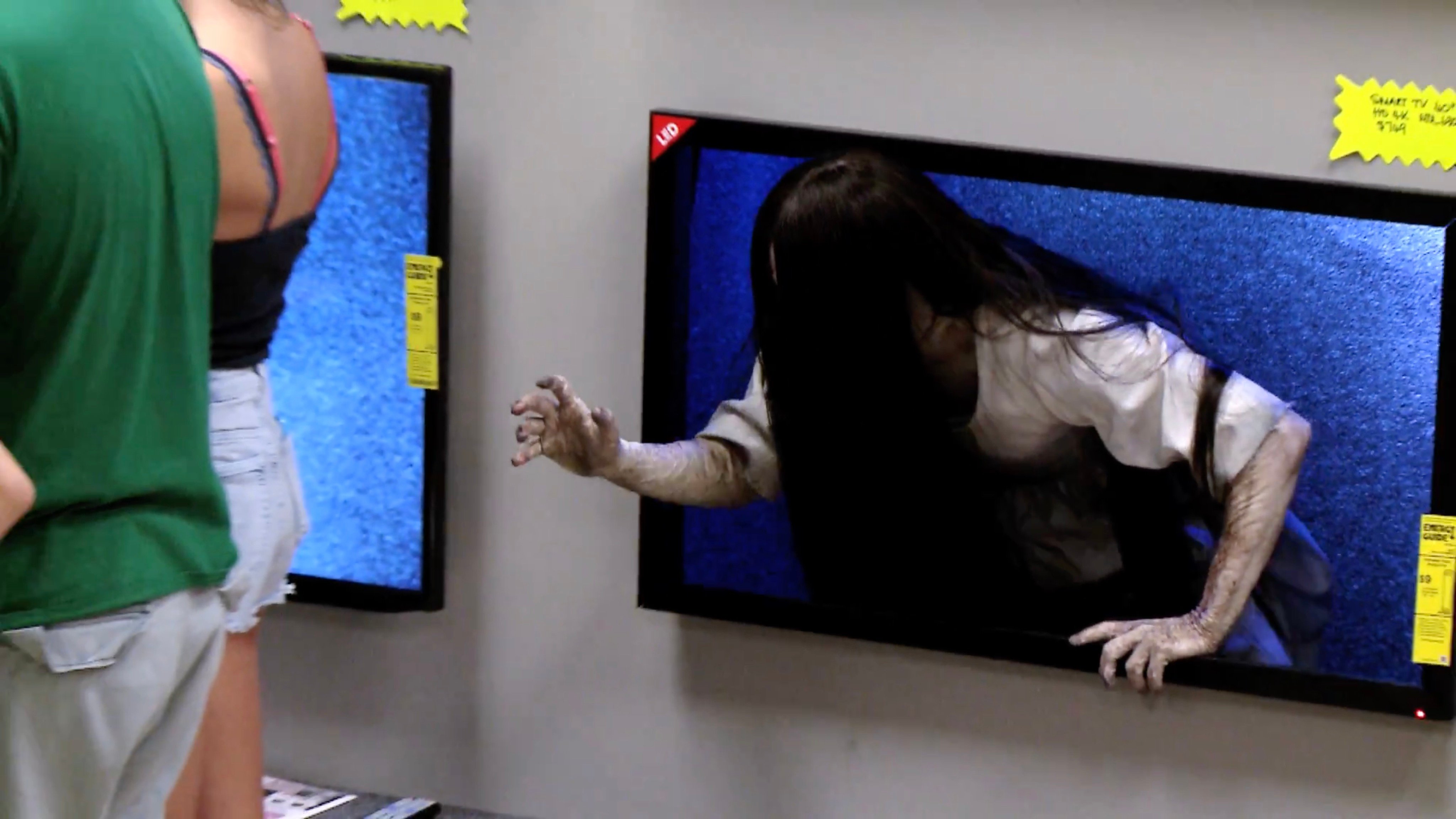 Watch the 'Rings' Girl Prank Customers by Crawling Out of Televisions! -  Bloody Disgusting