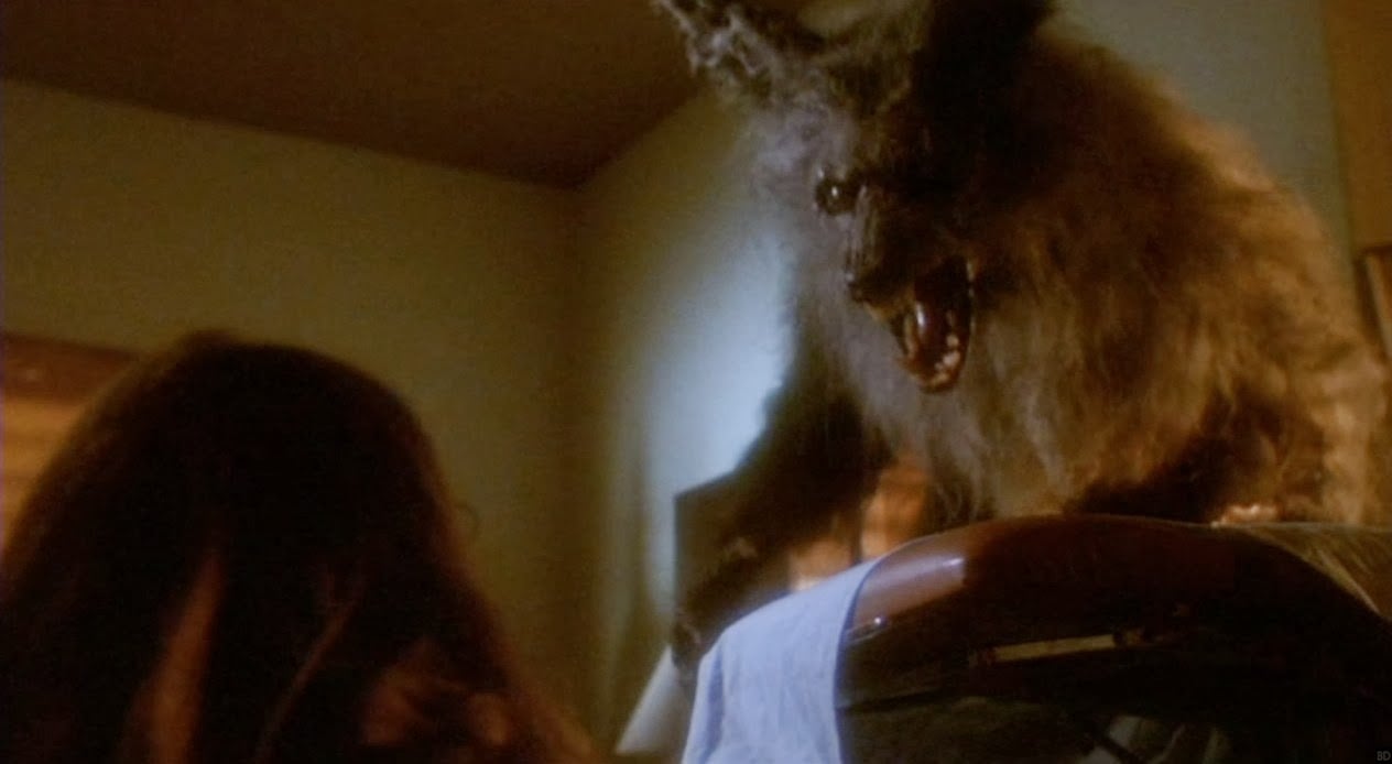 Image is from the film 'The Howling' (1981). A werewolf in wolf form looms over a casket and bares its teeth at a young woman.
