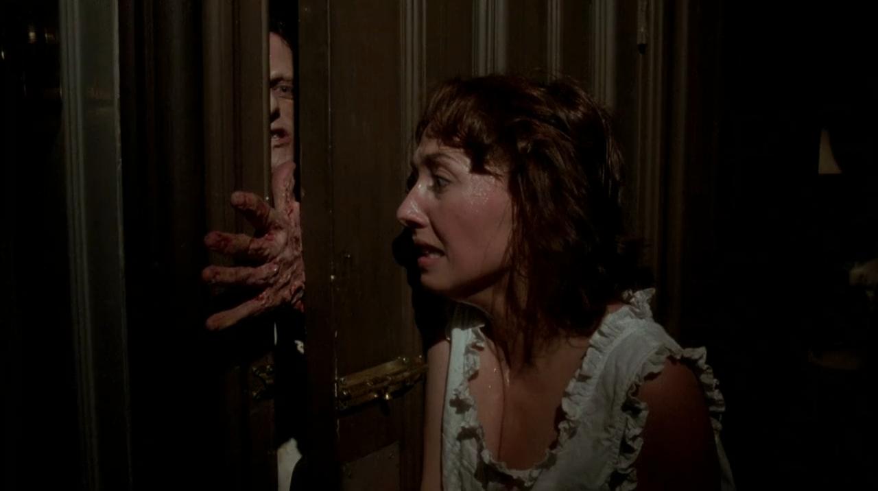 Debbie (Dawna Wightman) degloves an attacker's hand using a door