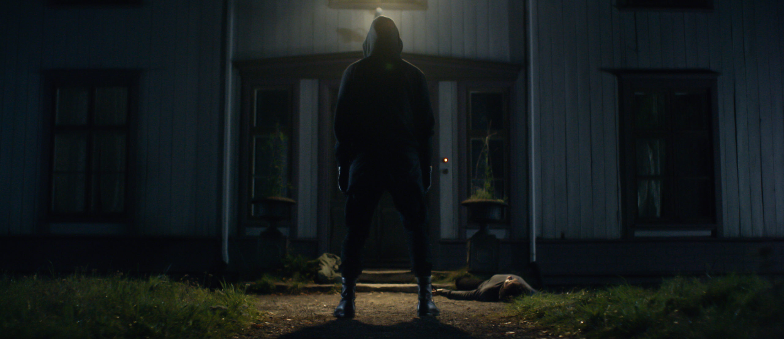 Dark WIndows hooded figure stands over body