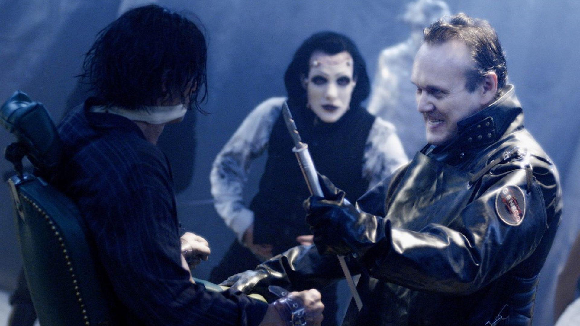 The Repo Man threatens a victim in Repo! The Genetic Opera.